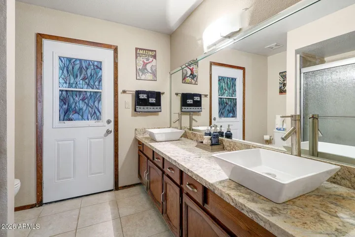 Double sink full 2nd bathroom with outside access door.