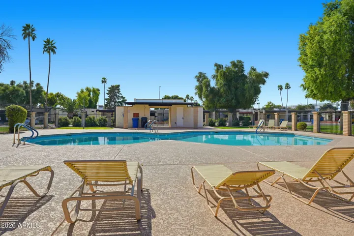 Views of palm trees and nice sitting areas by the sparkling pool!