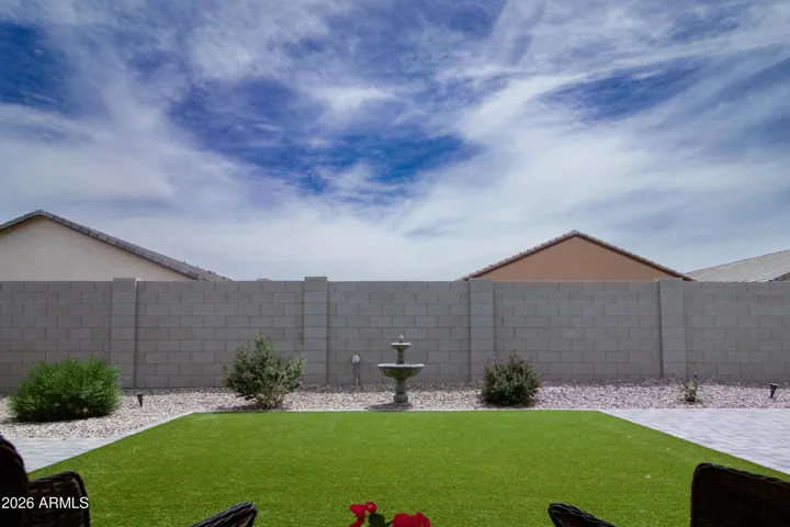 No maintenance turf with gorgeous plants and a calming fountain..Life's good!