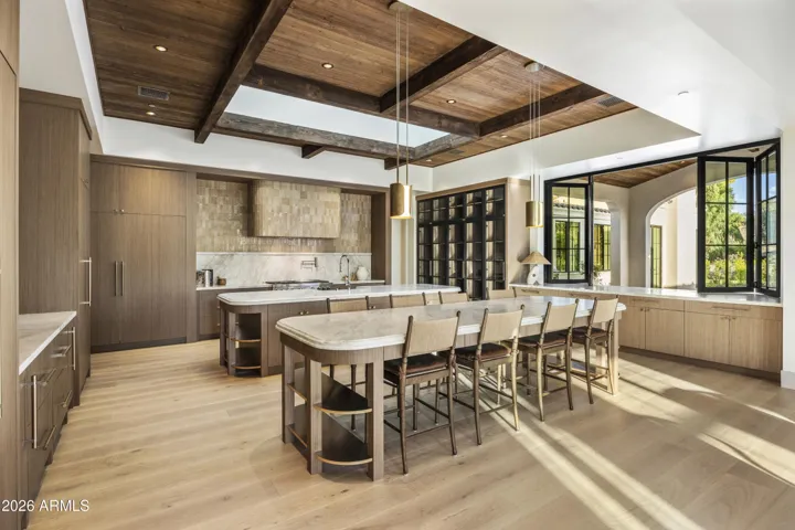 Natural wood ceiling with oversized skylight above the rear island, featuring integrated operable daylight shades and spotlights