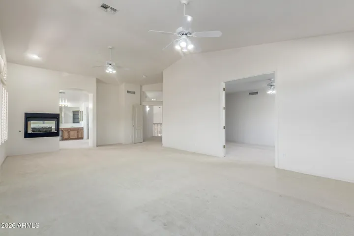 Vast primary bedroom with dual sided gas fireplace.