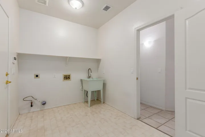 Large seperate enclosed laundry room with sink, with access to garage.