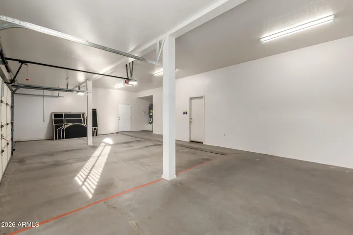 Large 3 car garge and extra stall space. Door to outside side yard.