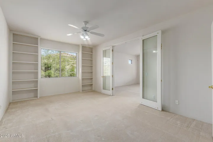 Third upstairs bedroom with door to primary bedroom.