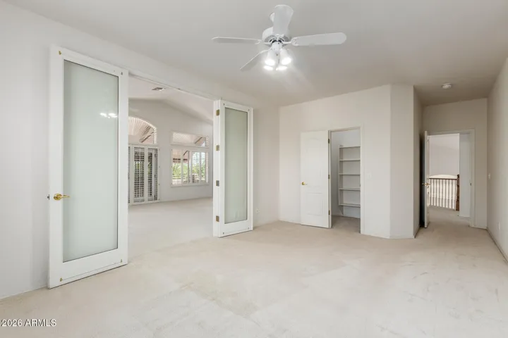Third upstairs bedroom with walk-in closet, access to hallway, also has side door to primary bedroom.