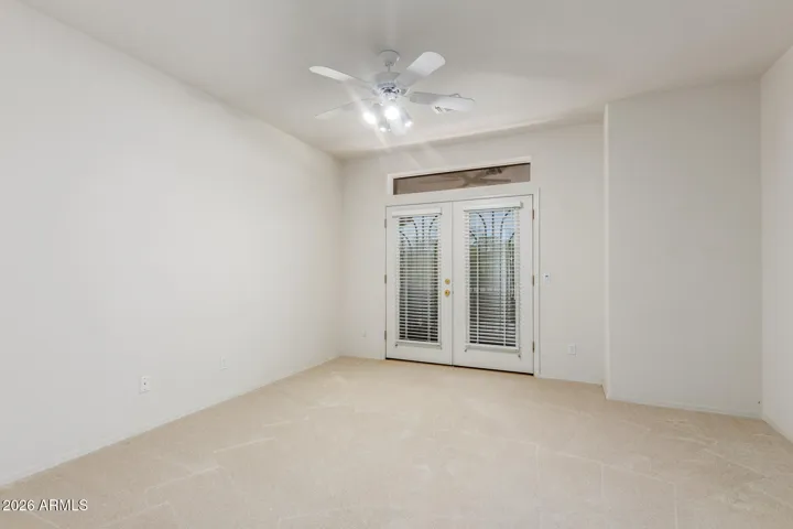 First upstairs bedroom with it's own personal balcony over looking the front of the house with a walk-in closet.
