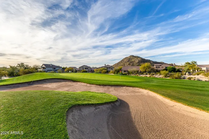 View of the home and mountain from other side of the green in front of home.