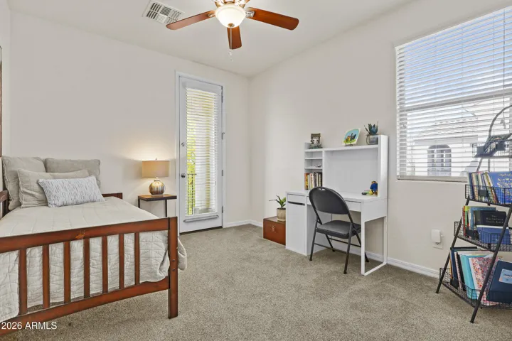 3rd Bedroom upstairs with walk in closet and door to the balcony.