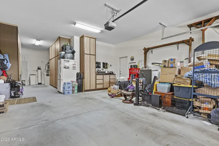 3 car tandem garage with nice built in cabinets and work space.