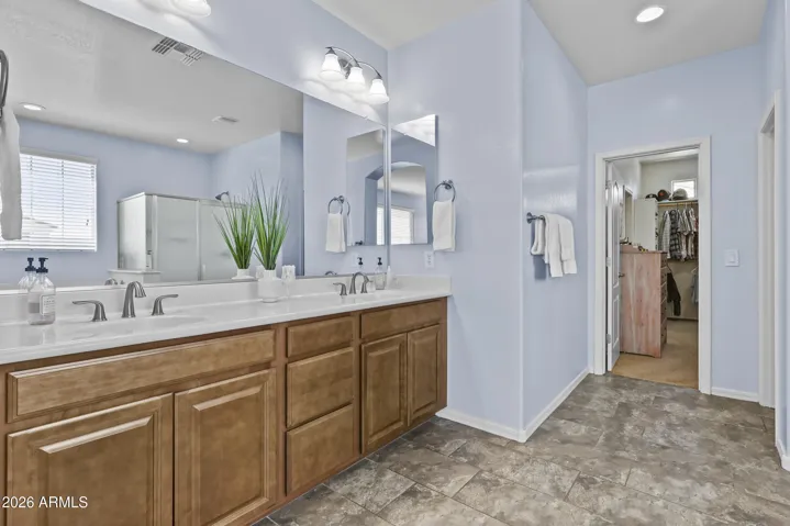 Master bath with double sinks, large walk in closet, tub, shower and calming designer paint.