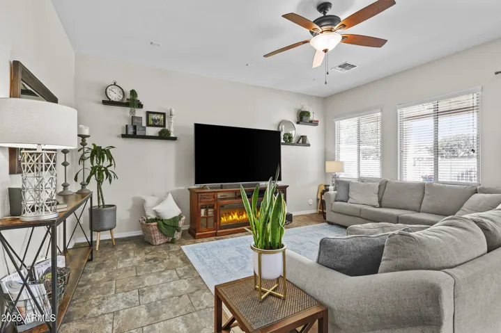 Great room downstairs with large windows and plenty of room to gather