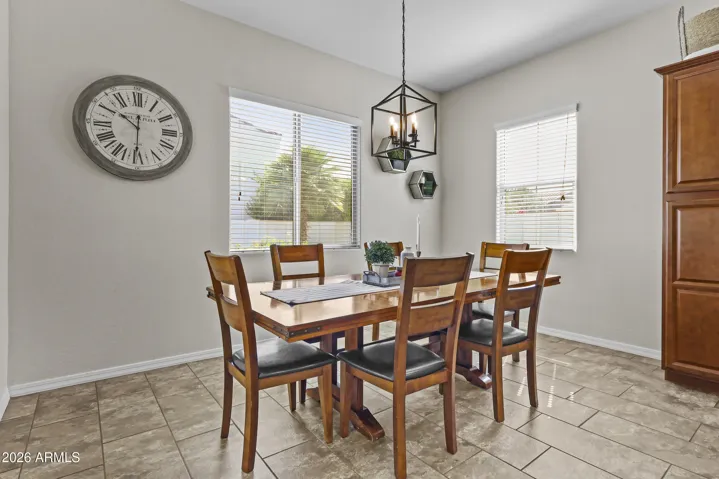 Dining area with updated lighting and room for a large table.