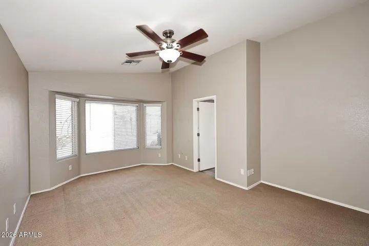 Large primary bedroom at the back/north end of the home, with direct pool access.