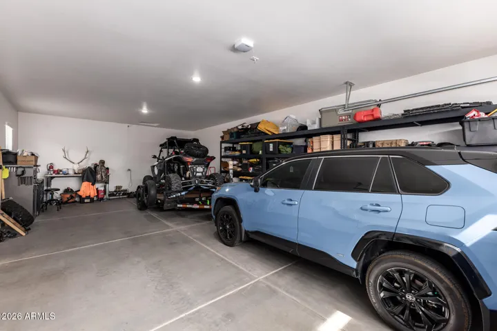 Oversized 4-car garage with ample storage, workspace potential, and room for vehicles or recreational equipment in this Surprise home.