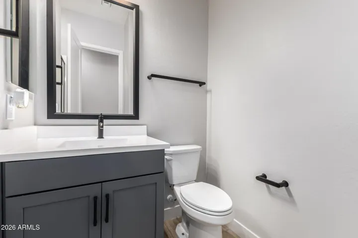 Stylish bathroom featuring a sleek vanity, modern fixtures, and clean finishes, offering convenience and updated design in this Surprise home.