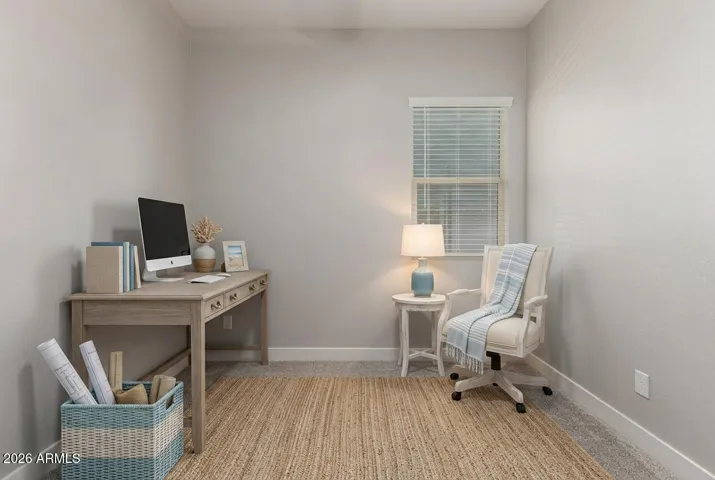 Virtually staged room demonstrating potential as a home office or guest bedroom with natural light and modern finishes in Surprise.