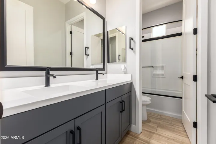 Stylish guest bathroom with modern vanity, updated fixtures, and tub-shower combo, offering convenience and comfort in this Surprise home.