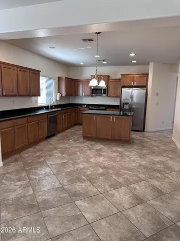 Amazing eat-in kitchen with cabinets galore, kitchen island, stainless steel appliances, gas range and open to spacious family room