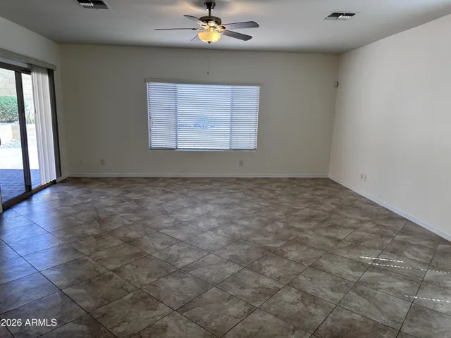 Family room from kitchen. Sliding doors on side lead to covered back patio and yard