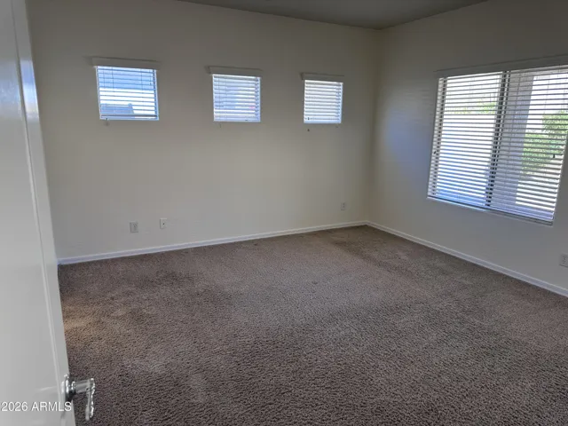 Primary bedroom downstairs with clerestory windows, French door and views to back yard