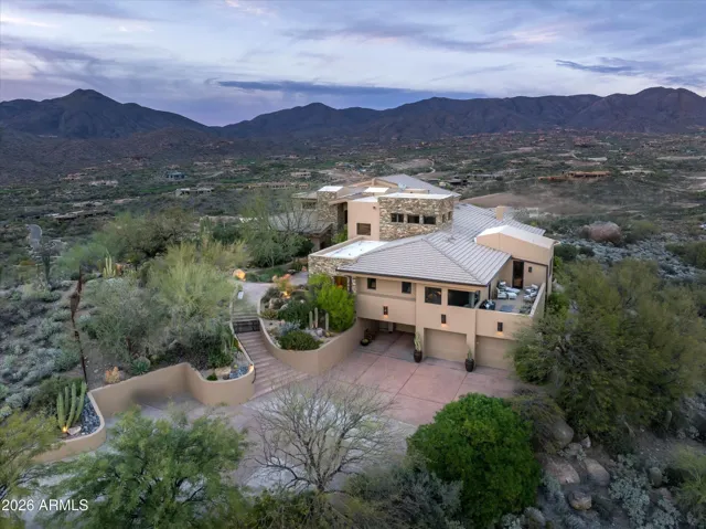 Sitting high above the Golf Courses on ~ 5 Acres in Double gated guard Community