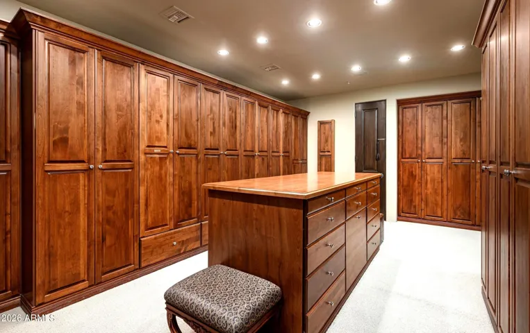 Custom cherry cabinetry with clothes shut and separate shoe closet