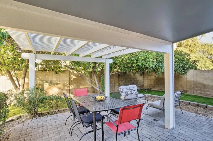 The pergola over the outdoor dining table adds shade but lets the light filter in.