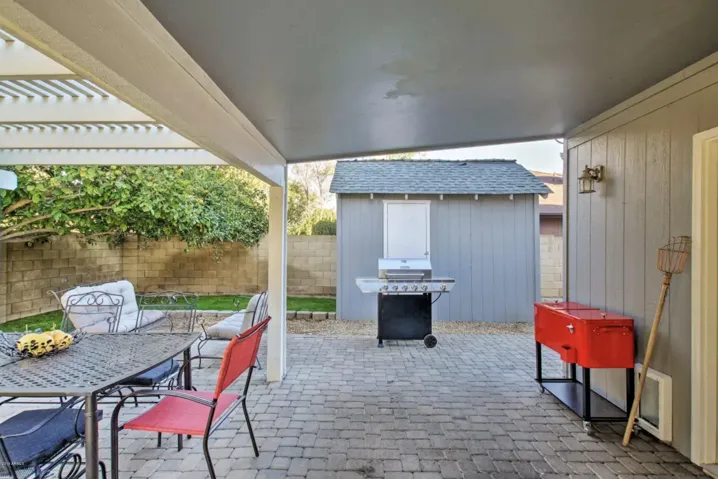 The back patio features a propane BBQ, outdoor ice chest and plenty of seating to enjoy the serene setting.