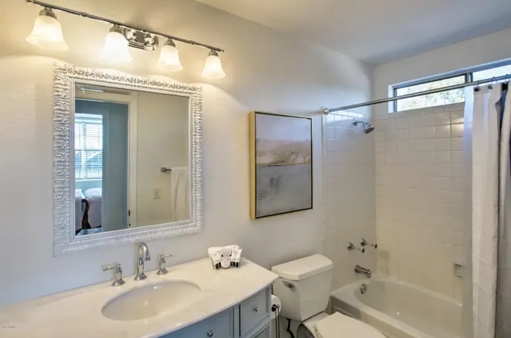 The upstairs hall bath has been remodeled with a new vanity, mirror and lighting.