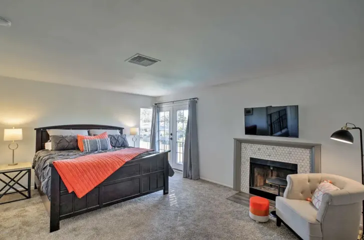The primary also has French doors that open onto a Juliet railing.