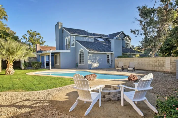 The expansive backyard includes a fire pit and a sunning area, plus more cooling grass.