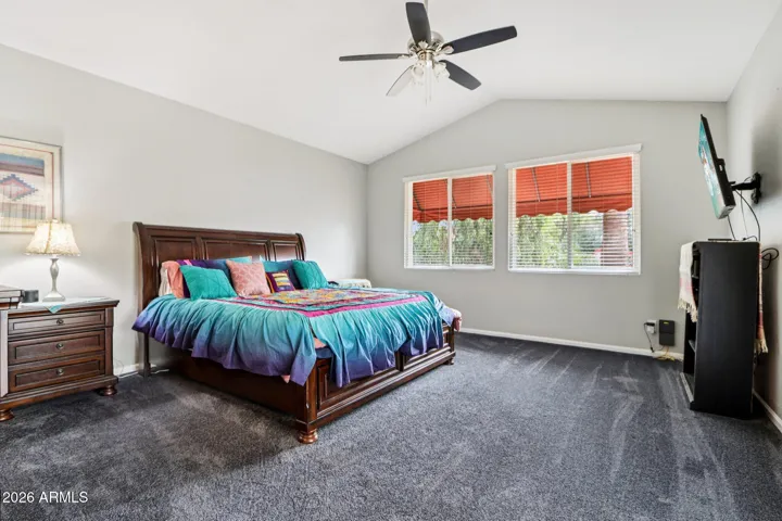 spacious bedroom with vaulted ceilings