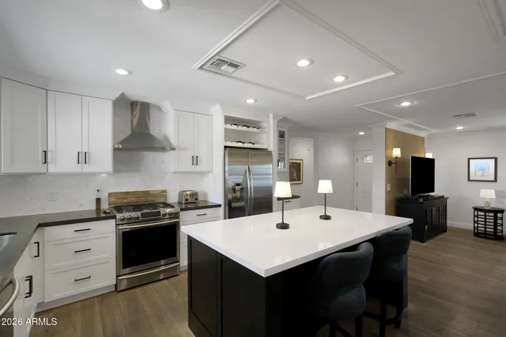 Kitchen opens to great room and looks out towards backyard oasis