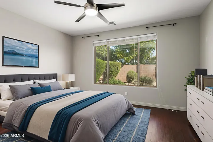 The spacious primary bedroom offers a peaceful retreat with soft natural light and a calming atmosphere designed for rest and relaxation.