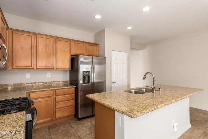 Granite countertops and stainless steel appliances anchor the kitchen, creating a classic and well appointed setting.