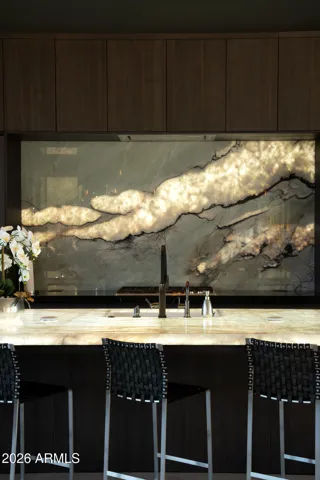 Crystal Aquamarine Brazilian Quartzite – selected slab by slab to echo the profile and palette of Mt. Lemmon visible beyond the glass; a kinetic horizon of light and stone