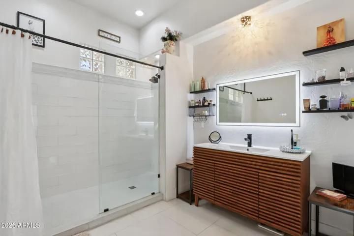 Custom tiled walk in shower, modern vanity & LED back lit mirror