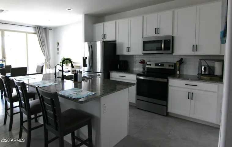 Stainless steel appliances, black hardware, RO installed in island.
