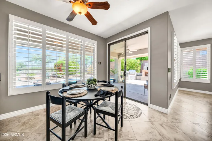 Casual dining area looks out to pool and patio