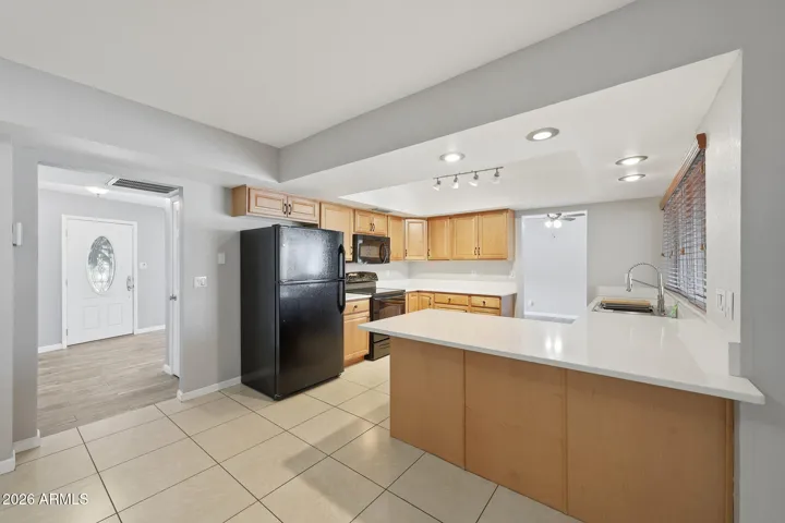 Spacious kitchen with quartz counters and upgraded chef sink.