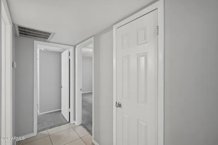 Hallway view of pantry, guest bath and bedrooms 2 & 3