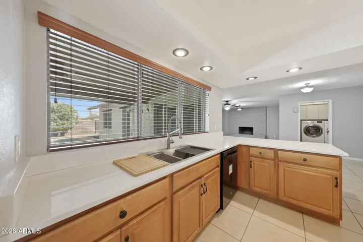 Kitchen view to back yard and hearth room/fireplace