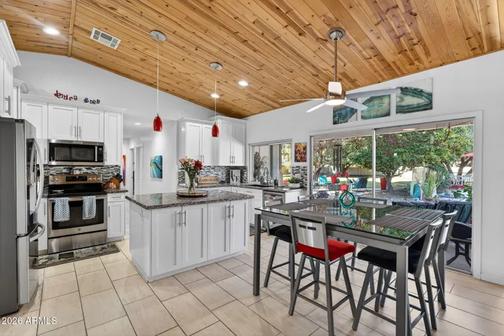 Vaulted ceilings throughout great room, with can lighting in kitchen