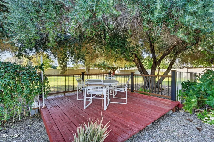 The dining patio is a redwood deck nestled beneath a mature olive tree to keep it shady....