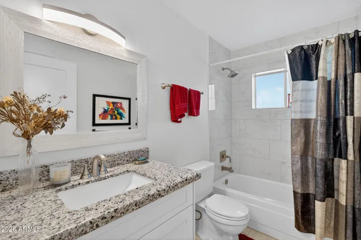 Full guest bath with tub, shower, and custom cabinet. Granite, of course....