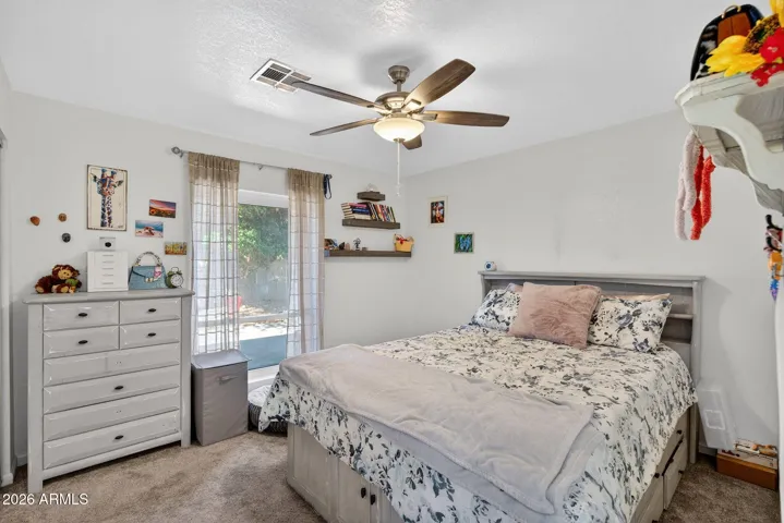 Bedroom 5 offers ceiling fan and another large window, with views to the park like back yard.
