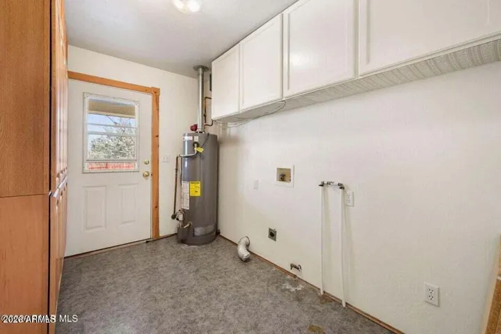 Laundry Room has access to the back porch and yard. Added storage.