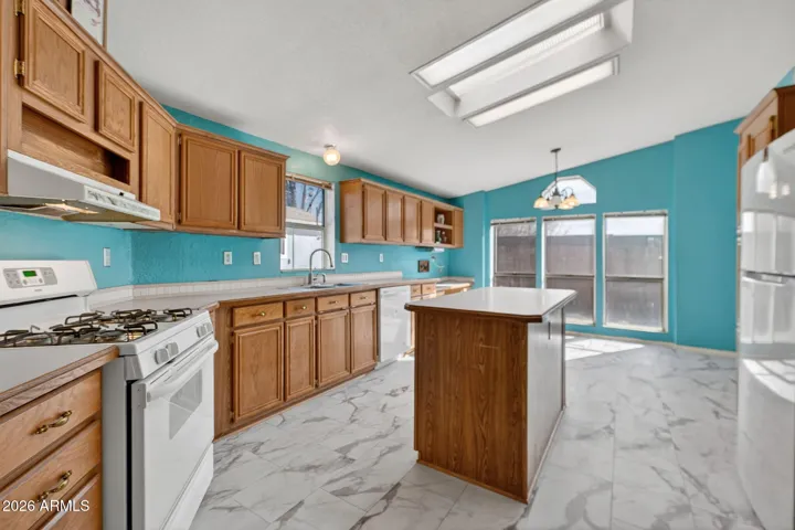 This kitchen is bathed in natural light and offers an eat-in area.