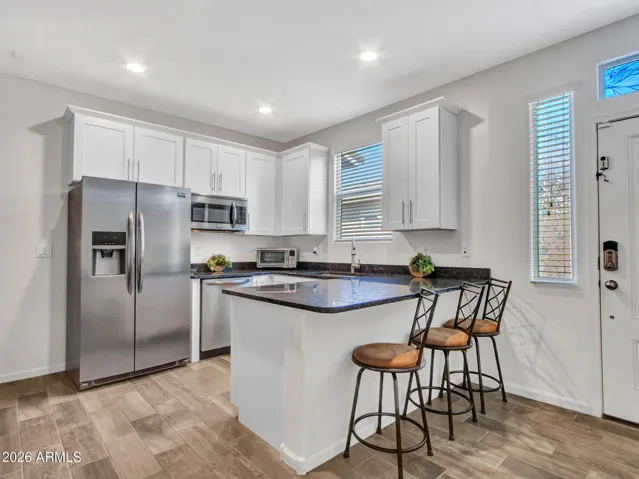 Next Gen kitchen, with black granite, and white shaker cabinets.