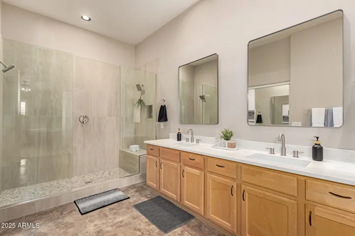 remodeled master bath with large shower with 2 shower heads